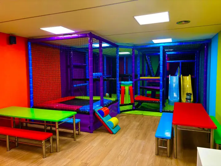 Parque infantil con toboganes y mesas de colores